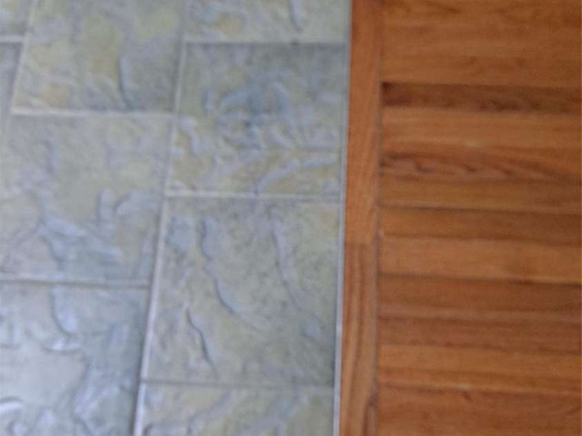 4444 Rock Barn Road, Claremont, NC 28610.  MLS# CAR4147820, YatesRealty ID 112. Tile on kitchen floor adjacent to hardwood floor in dining area