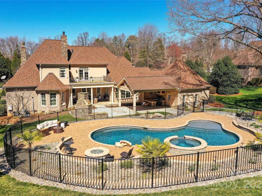 7295 Three Sisters Lane, Concord, NC 28027.  MLS# CAR4239485, YatesRealty ID 11233. Amazing, Salt Water Pool/Spa with plenty of pool deck for seating & fire pit area makes this home a true gem!