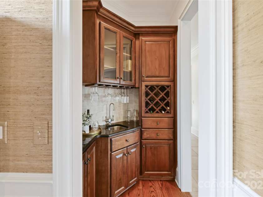 7295 Three Sisters Lane, Concord, NC 28027.  MLS# CAR4239485, YatesRealty ID 11233. Bar Area with built in wine rack & custom cabinetry!