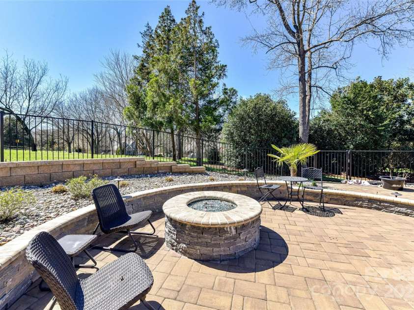 7295 Three Sisters Lane, Concord, NC 28027.  MLS# CAR4239485, YatesRealty ID 11233. Fire Pit Area cultivated for entertaining!