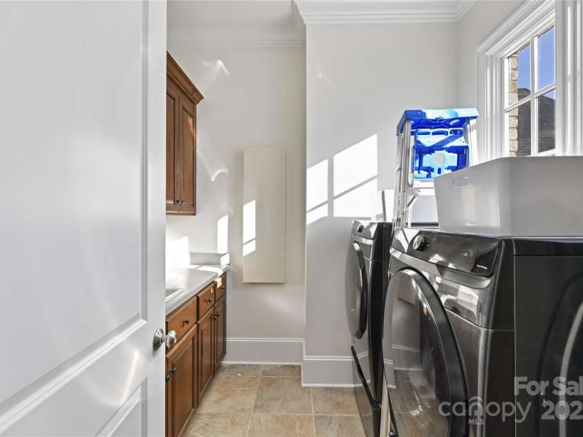 7295 Three Sisters Lane, Concord, NC 28027.  MLS# CAR4239485, YatesRealty ID 11233. Laundry Room on main level with sink, cabinetry & tile floors!
