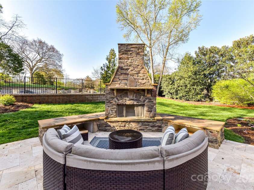7295 Three Sisters Lane, Concord, NC 28027.  MLS# CAR4239485, YatesRealty ID 11233. Outdoor Fireplace with bench seating!