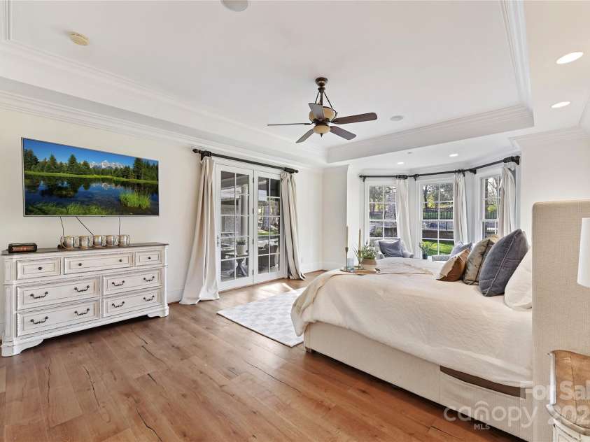 7295 Three Sisters Lane, Concord, NC 28027.  MLS# CAR4239485, YatesRealty ID 11233. Spacious Primary Suite on main level with tray ceiling, crown molding, bay window, recessed lights, hardwood floors, private bath & walk in closet!