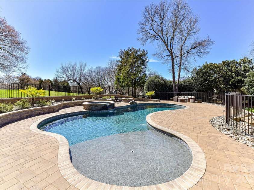 7295 Three Sisters Lane, Concord, NC 28027.  MLS# CAR4239485, YatesRealty ID 11233. Spectacular Pool/Spa (salt water) with plenty of decking for seating for family/friends!