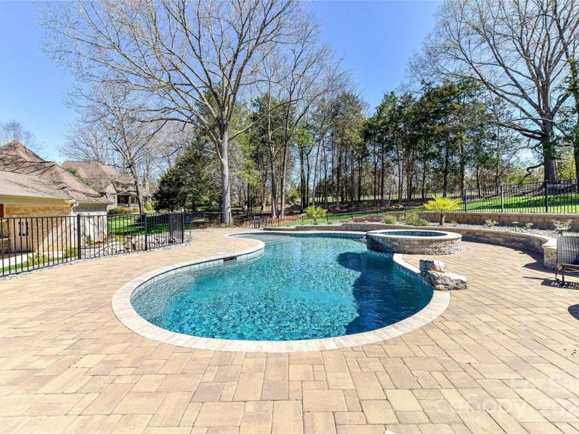 7295 Three Sisters Lane, Concord, NC 28027.  MLS# CAR4239485, YatesRealty ID 11233. Spectacular Pool/Spa (salt water) with plenty of decking for seating for family/friends!