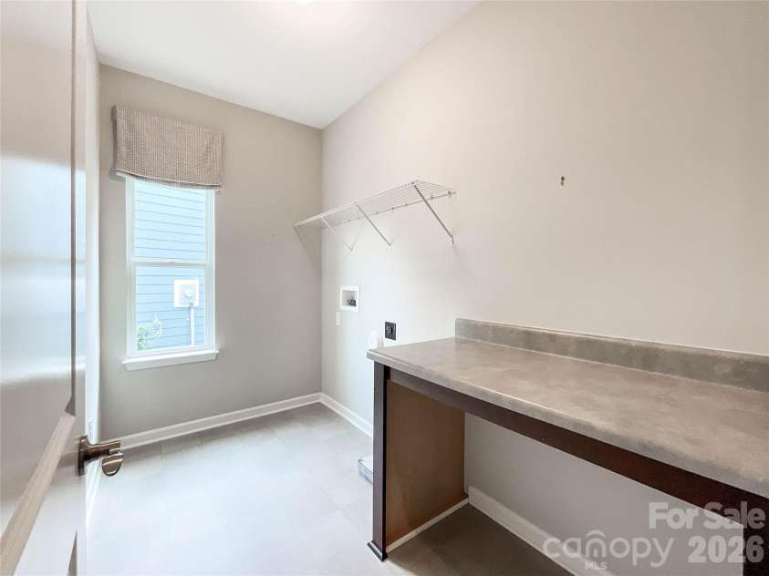 21228 Sanctuary Drive, Lancaster, SC 29720.  MLS# CAR4364757, YatesRealty ID 11249. Laundry room with folding table