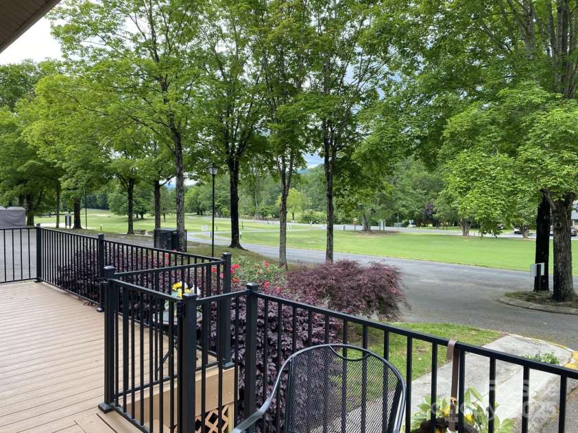 118 Lake Drive, Lake Lure, NC 28746.  MLS# CAR4254226, YatesRealty ID 11276. Front porch overlooks bald Mt golf course and Bald Mountain