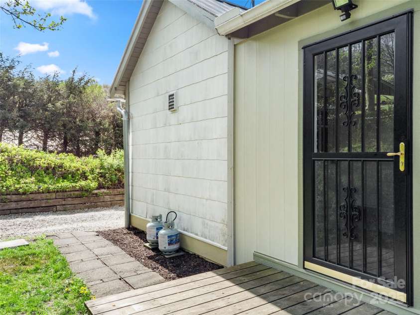 377 Cabin Road, Spruce Pine, NC 28777.  MLS# CAR4256421, YatesRealty ID 11280. Driveway with pavers to back deck entry