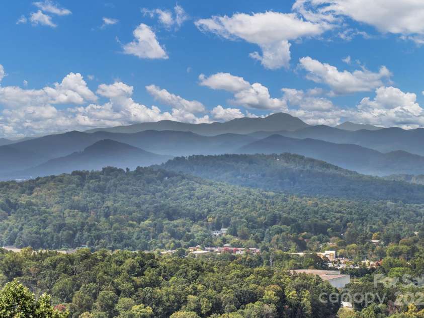 86 Distant View Drive, Asheville, NC 28803.  MLS# CAR4299899, YatesRealty ID 11339. 3 season room off the primary bedroom with direct access to the covered back porch.