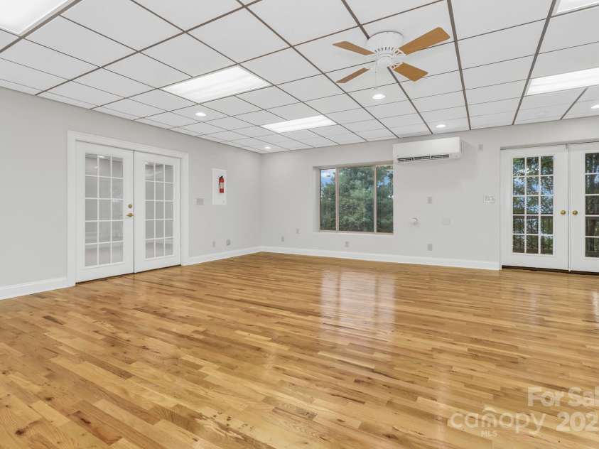 86 Distant View Drive, Asheville, NC 28803.  MLS# CAR4299899, YatesRealty ID 11339. 3rd level down massive rec room. Could be wood shop, game room with plents of space for a pool table or convert into a movie room complete with it's on bathroom. 