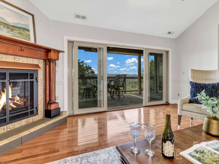 86 Distant View Drive, Asheville, NC 28803.  MLS# CAR4299899, YatesRealty ID 11339. Large living room on the main level with vaulted ceilings fireplace and views from every window. 