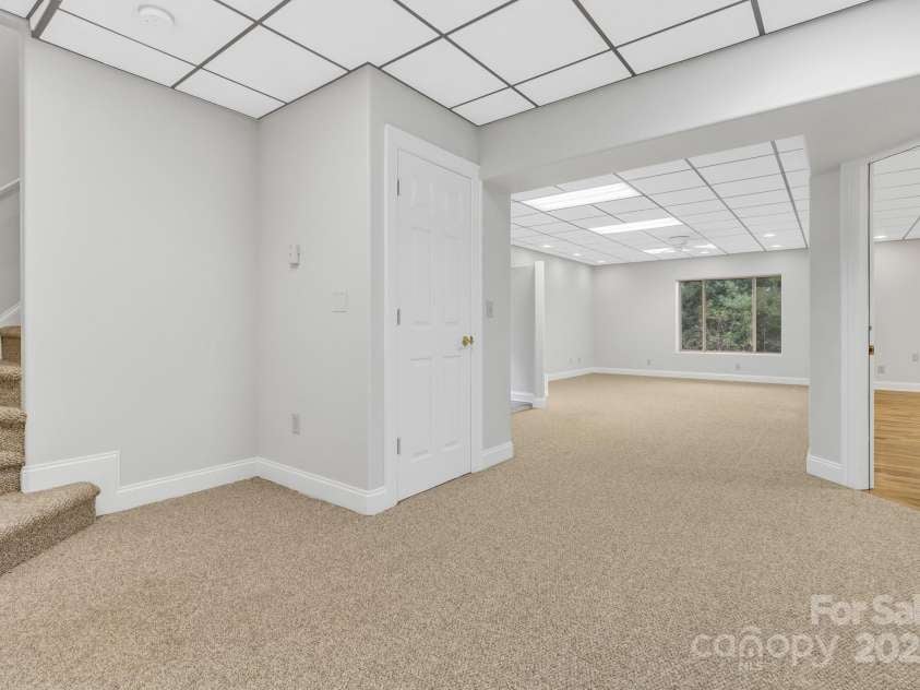 86 Distant View Drive, Asheville, NC 28803.  MLS# CAR4299899, YatesRealty ID 11339. Stairs from main level to lower level living and bedrooms 