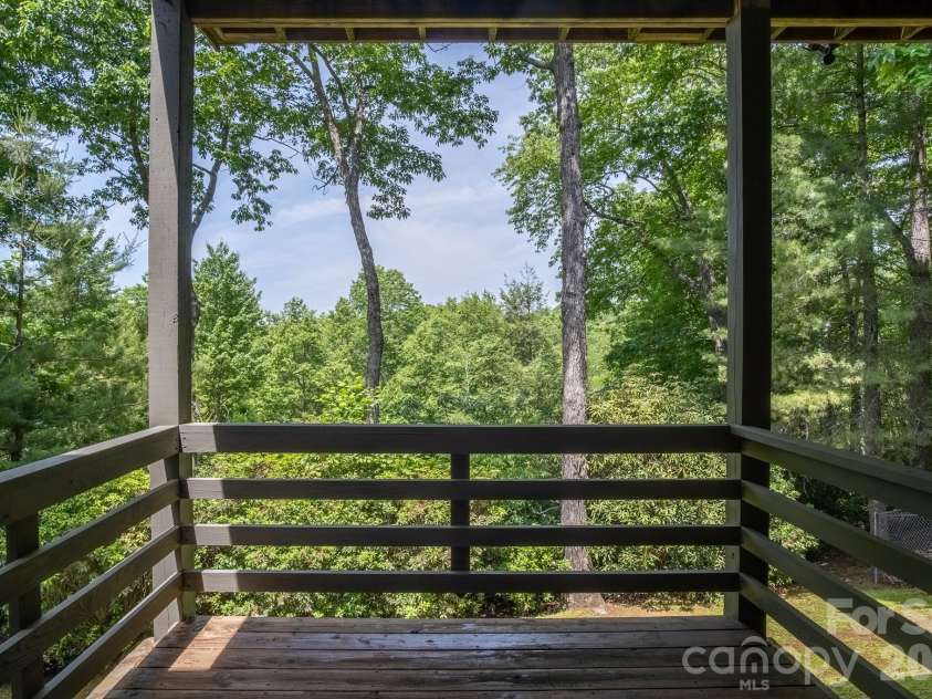 153 Brandy Ridge, Brevard, NC 28712.  MLS# CAR4366624, YatesRealty ID 11352. Covered Deck with Nature ViewsPrivate lower-level deck offering tranquil forest views and an ideal setting for morning coffee or evening relaxation.