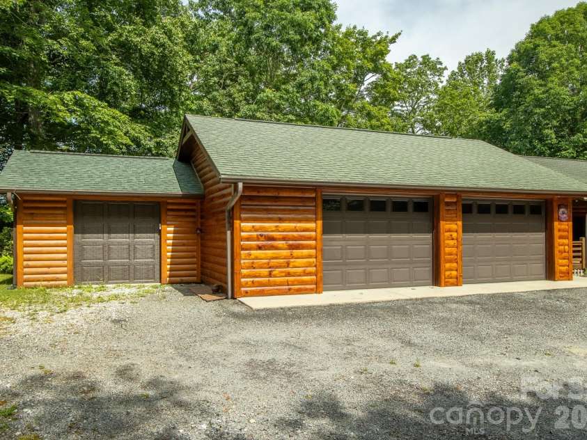 153 Brandy Ridge, Brevard, NC 28712.  MLS# CAR4366624, YatesRealty ID 11352. Detached Two-Car Garage + golf cart bay with Workshop BaySpacious detached garage featuring three overhead doors, including an oversized bay ideal for equipment storage, hobbies, or workshop space.