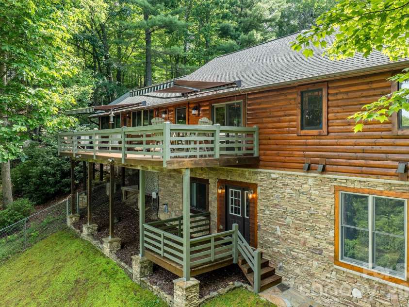 153 Brandy Ridge, Brevard, NC 28712.  MLS# CAR4366624, YatesRealty ID 11352. Rear Deck & Outdoor DiningSpacious rear deck with retractable awnings, multiple seating areas, and a private wooded backdrop. An ideal setting for outdoor dining, entertaining, or relaxing in the fresh mountain air.