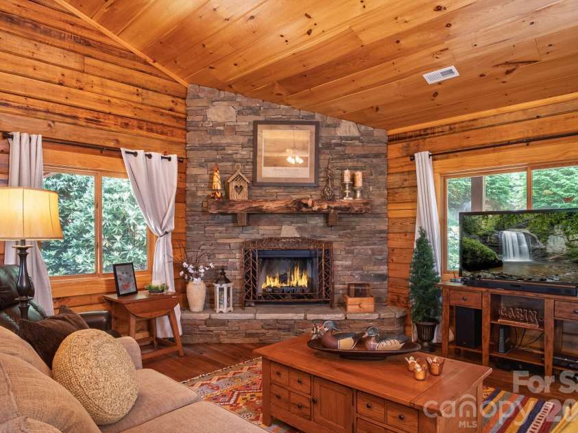 153 Brandy Ridge, Brevard, NC 28712.  MLS# CAR4366624, YatesRealty ID 11352. Stone Fireplace Feature WallBeautiful stacked-stone fireplace with vented gas logs creates a warm focal point for the main living area and enhances the home's mountain-lodge character.