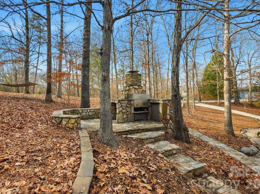 4737 Betty Davis Drive, York, SC 29745.  MLS# CAR4342456, YatesRealty ID 11374. After a day on the water, gather around the built-in stone fireplace and grill for relaxed evenings, great food, and even better company. This outdoor space was made for hosting!