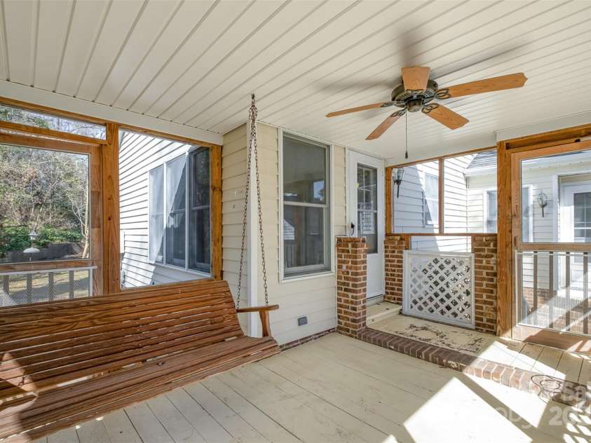 457 Birchwood Trail, Concord, NC 28025.  MLS# CAR4223374, YatesRealty ID 11376. Screen porch with swing