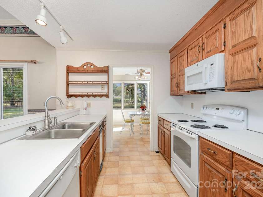 240 Partridge Run, Salisbury, NC 28147.  MLS# CAR4305095, YatesRealty ID 11401. Gallery-style kitchen, leading to bright sunroom.