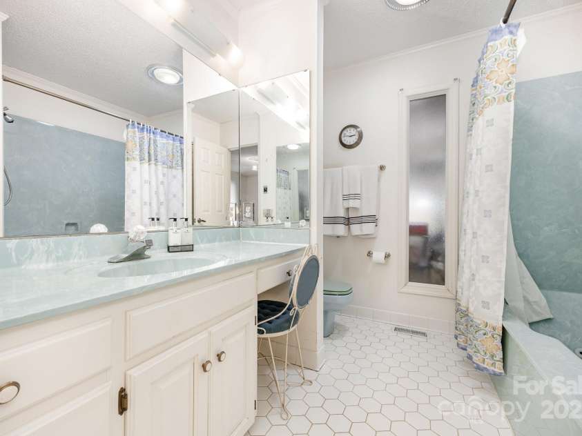 240 Partridge Run, Salisbury, NC 28147.  MLS# CAR4305095, YatesRealty ID 11401. This bathroom has a jetted tub in combination with a shower. Another useful amenity is the mirror on three walls, along with a built in vanity.