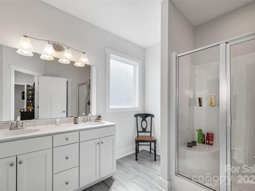 22 Hyde Park Place, Arden, NC 28704.  MLS# CAR4239022, YatesRealty ID 11411. Large Walk in Shower in Primary Bedroom