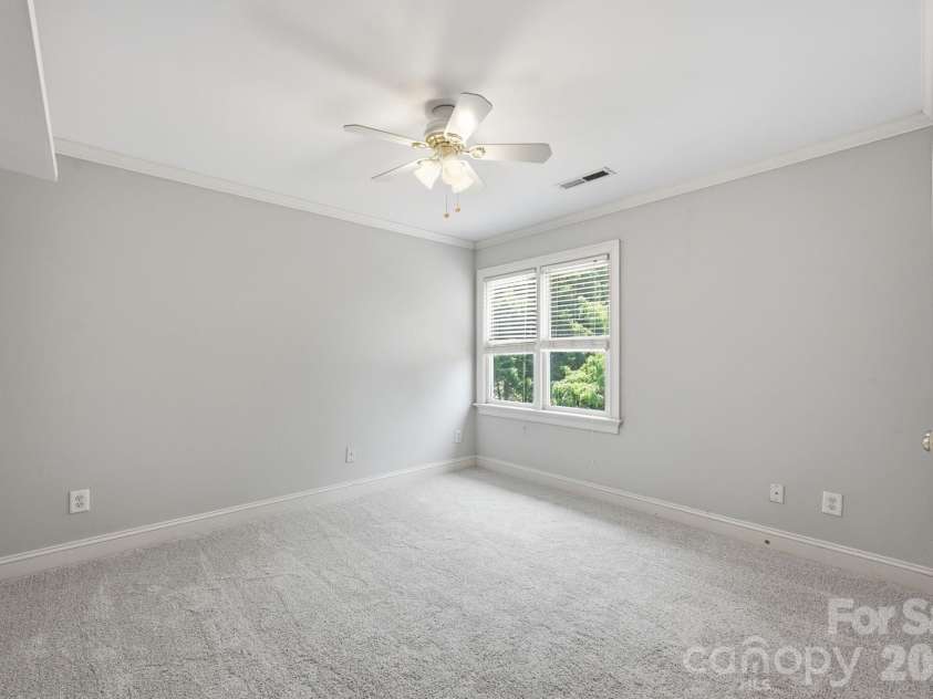 118 Broadbill Drive, Mooresville, NC 28117.  MLS# CAR4395594, YatesRealty ID 11435. Upper level bedroom 4 has double closet, ceiling fan and backyard view.