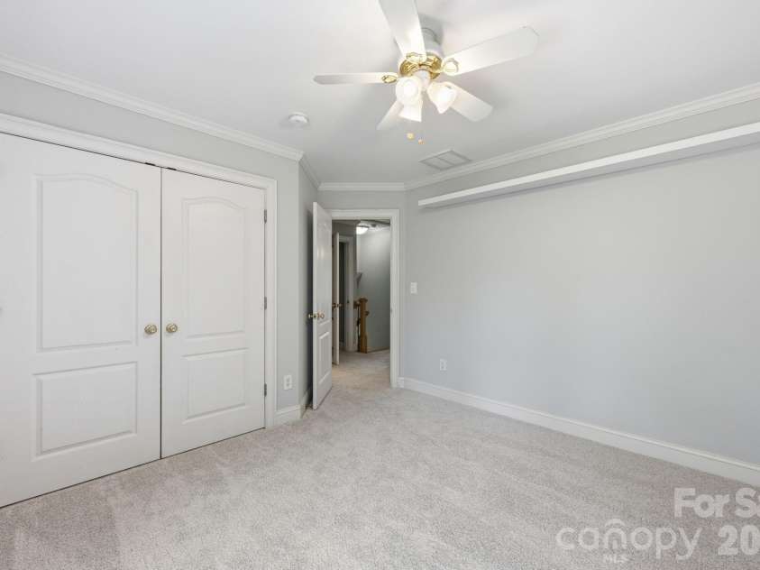 118 Broadbill Drive, Mooresville, NC 28117.  MLS# CAR4395594, YatesRealty ID 11435. Upper level bedroom 4 has double closet, ceiling fan and backyard view.