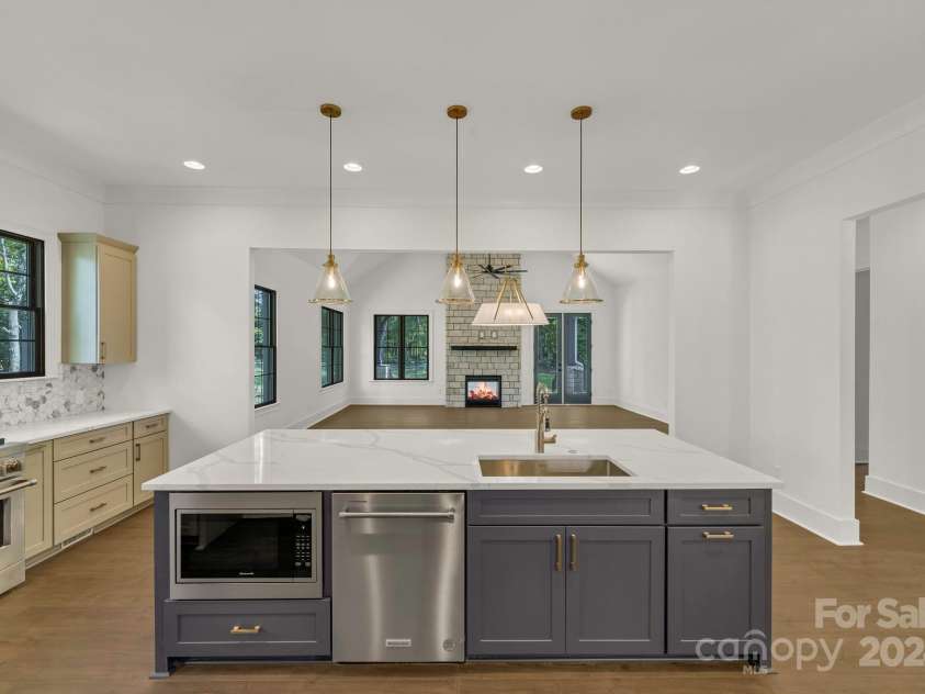 1106 Anniston Place, Indian Trail, NC 28079.  MLS# CAR4163544, YatesRealty ID 1144. Kitchen Island ~ View into Living Room