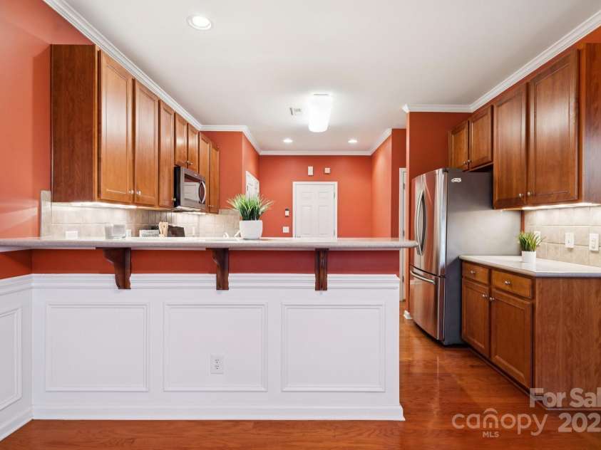 8408 Brookings Drive, Charlotte, NC 28269.  MLS# CAR4284673, YatesRealty ID 1145. The kitchen has a bar area for wining and dining with or without company.