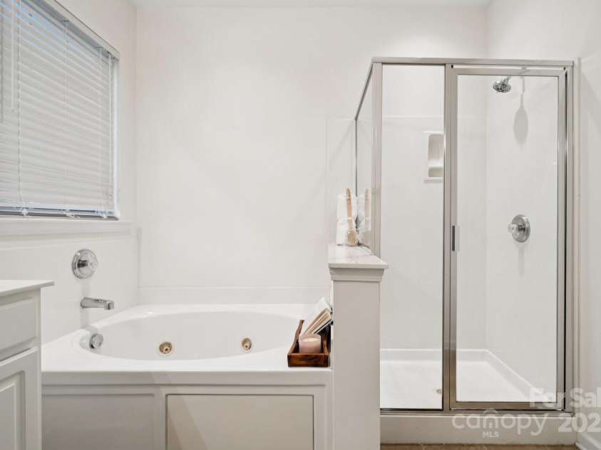 8408 Brookings Drive, Charlotte, NC 28269.  MLS# CAR4284673, YatesRealty ID 1145. Unwind in the soaking jet pool tub with a book and a glass of your favorite drink or you can chose the walk in shower