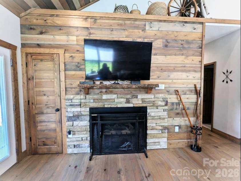 10 Rio Bravo Drive, Sylva, NC 28779.  MLS# CAR4296478, YatesRealty ID 1146. Fireplace with stone & wood accent wall