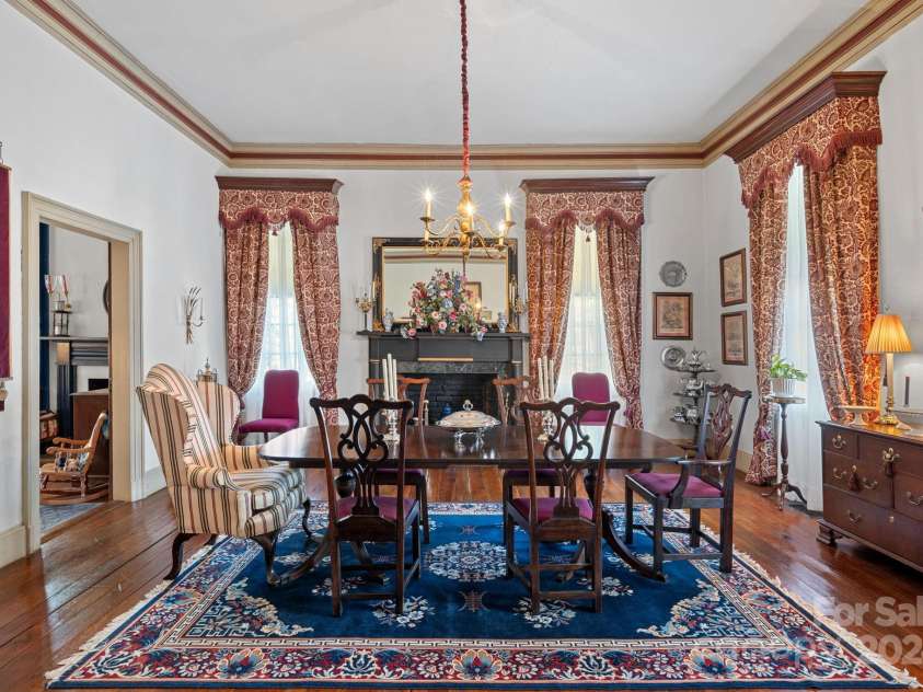 104 Leslie Loop, Mooresville, NC 28115.  MLS# CAR4195674, YatesRealty ID 11464. The Dining Room has a Federal mantlepiece with granite surround and features 14-ft lath & plaster walls with beautiful woodwork in the crown moldings & cornice boards.