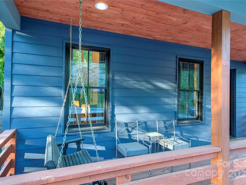 12 Waverly Road, Asheville, NC 28803.  MLS# CAR4256160, YatesRealty ID 11477. Front porch with swing