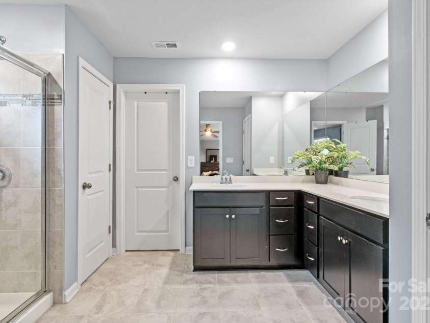 121 Little Kennerly Drive, Mooresville, NC 28115.  MLS# CAR4241437, YatesRealty ID 11479. Primary Ensuite includes separate sinks, drawers, and tiled shower.