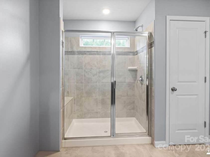 121 Little Kennerly Drive, Mooresville, NC 28115.  MLS# CAR4241437, YatesRealty ID 11479. Shower with built-in bench.