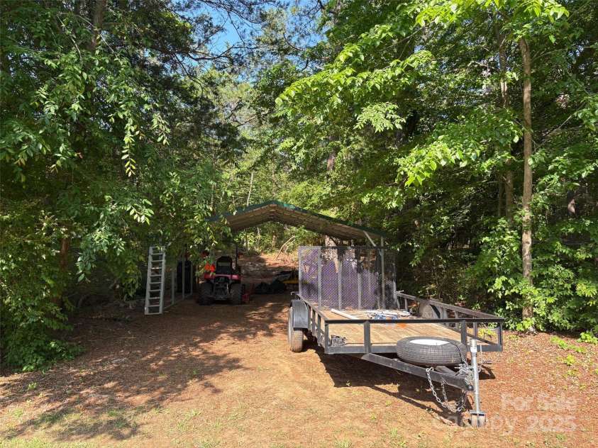 1355 Woodrun Court, Rock Hill, SC 29732.  MLS# CAR4256126, YatesRealty ID 11497. Carport in the trees on left of driveway.