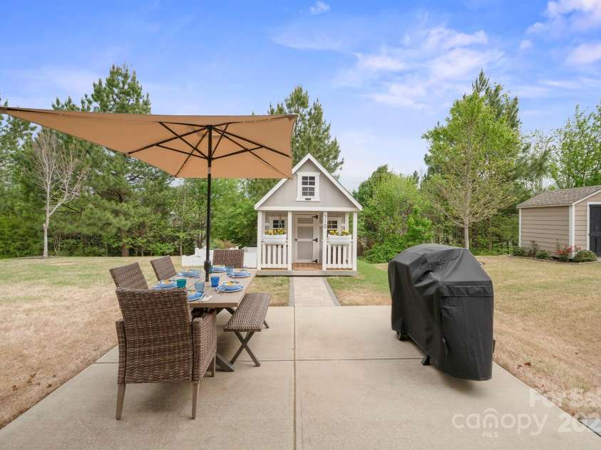 13115 Union Square Drive, Huntersville, NC 28078.  MLS# CAR4247415, YatesRealty ID 11499. Extended patio for grilling and dining and the adorable childrens house or storage