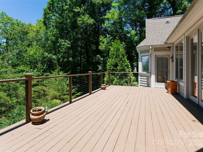 57 Old Hickory Trail, Hendersonville, NC 28739.  MLS# CAR4150896, YatesRealty ID 115. A large open air back deck is the perfect place to enjoy the serene surroundings