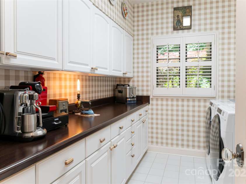 57 Old Hickory Trail, Hendersonville, NC 28739.  MLS# CAR4150896, YatesRealty ID 115. The large walk-in laundry room also provides ample pantry storage space