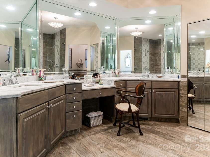 57 Old Hickory Trail, Hendersonville, NC 28739.  MLS# CAR4150896, YatesRealty ID 115. The primary bathroom features double vanities with abundant counter space