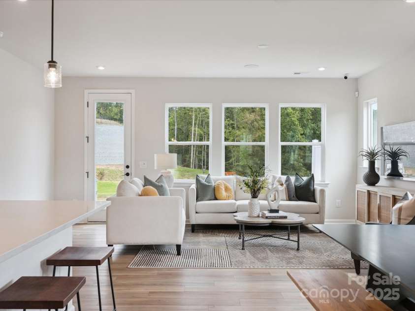 619 Webster Lane, Cramerton, NC 28032.  MLS# CAR4322006, YatesRealty ID 1150. Great Room Leading to Outdoor Living.  *Model Photos | Actual Finishes, Structural Selections, and Orientation May Vary.