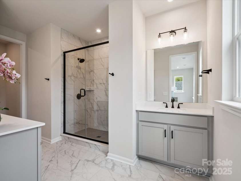 619 Webster Lane, Cramerton, NC 28032.  MLS# CAR4322006, YatesRealty ID 1150. Primary En Suite Bath with Marble-Look Floor Tile.  *Model Photos | Actual Finishes, Structural Selections, and Orientation May Vary.