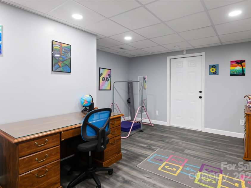77 Roberts Ridge Drive, Etowah, NC 28729.  MLS# CAR4241039, YatesRealty ID 11510. Finished basement area