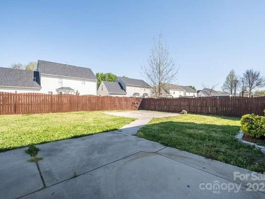 10146 Hawkeye Drive, Charlotte, NC 28273.  MLS# CAR4254398, YatesRealty ID 11525. Backyard with a concrete pad for a firepit or a gazebo