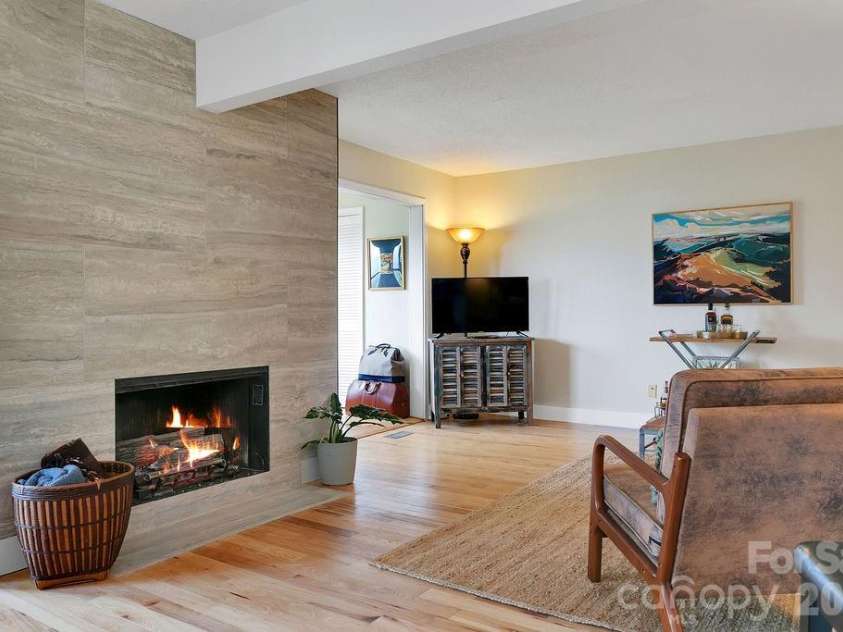 216 Tinequa Drive, Brevard, NC 28712.  MLS# CAR4365636, YatesRealty ID 11539. Fireplace with propane logs