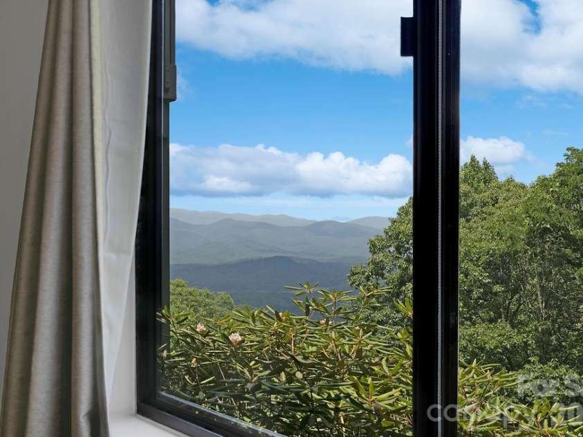 216 Tinequa Drive, Brevard, NC 28712.  MLS# CAR4365636, YatesRealty ID 11539. View from primary bedroom windows...