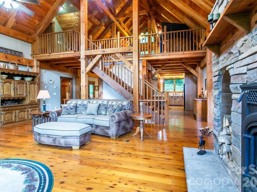58 Great Aspen Way, Black Mountain, NC 28711.  MLS# CAR4366858, YatesRealty ID 11545. A better look at the gleaming wood floors and a peek into the kitchen on the right beyond the stairs.
