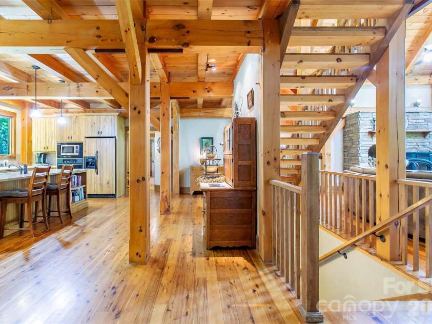 58 Great Aspen Way, Black Mountain, NC 28711.  MLS# CAR4366858, YatesRealty ID 11545. A look at the kitchen island, stairway, and sunny living area.