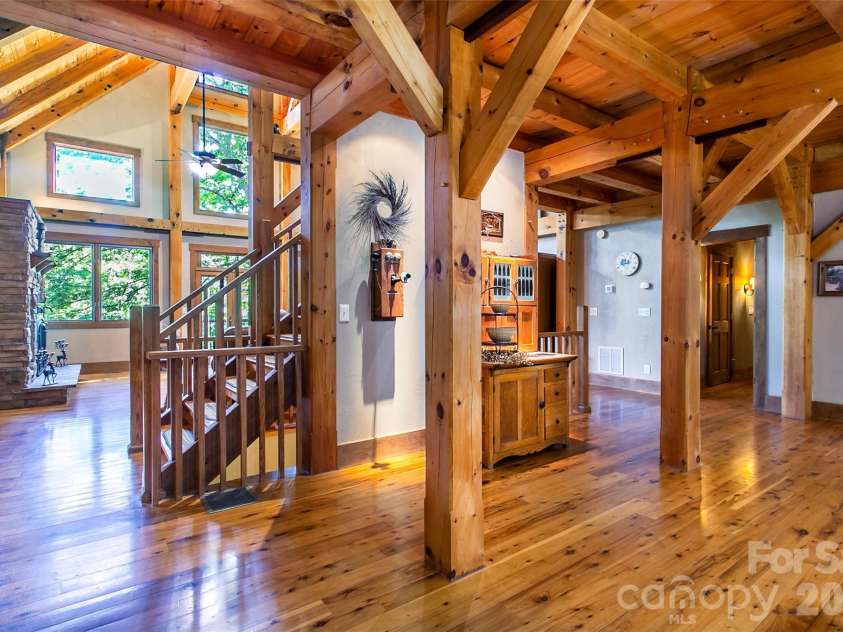 58 Great Aspen Way, Black Mountain, NC 28711.  MLS# CAR4366858, YatesRealty ID 11545. Angle from the kitchen looking into the living room. You can put a formal china cabinet on the wall near the stairs facing the kitchen.