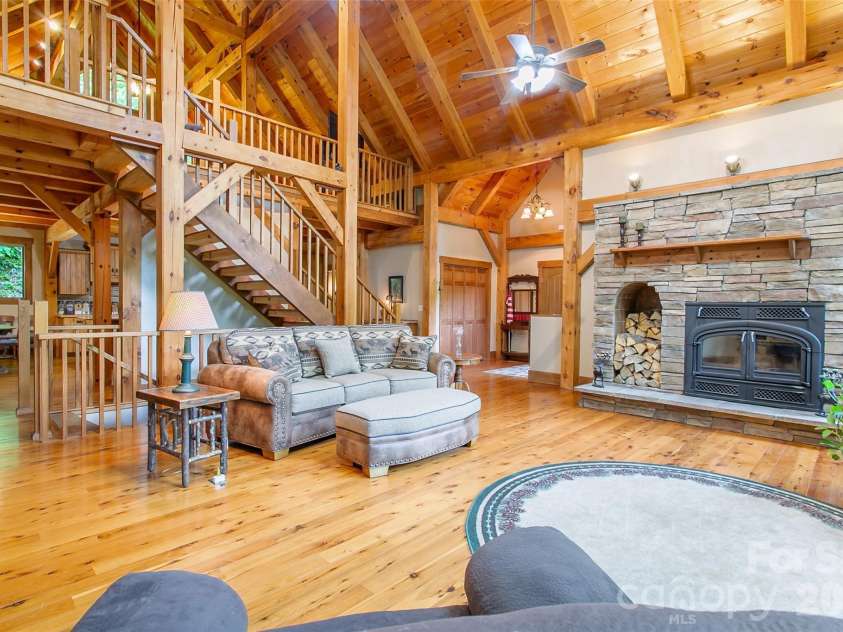 58 Great Aspen Way, Black Mountain, NC 28711.  MLS# CAR4366858, YatesRealty ID 11545. Another look at the sunny living room, the entry, loft, dining area, and wood-burning fireplace.